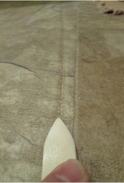 Forensic Floors - Linoleum defect in carpeting wear area.